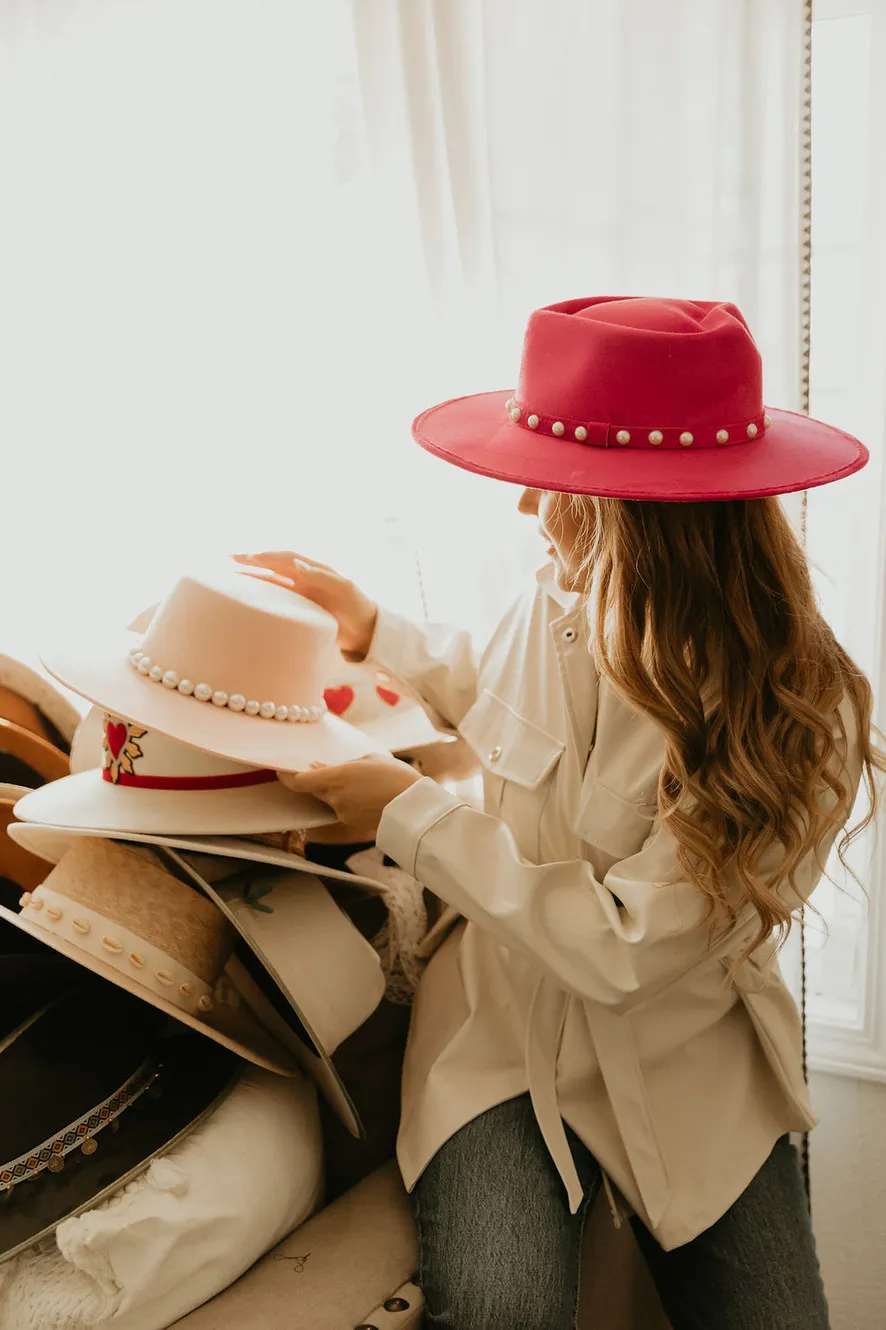 A model choosing between handmade hats