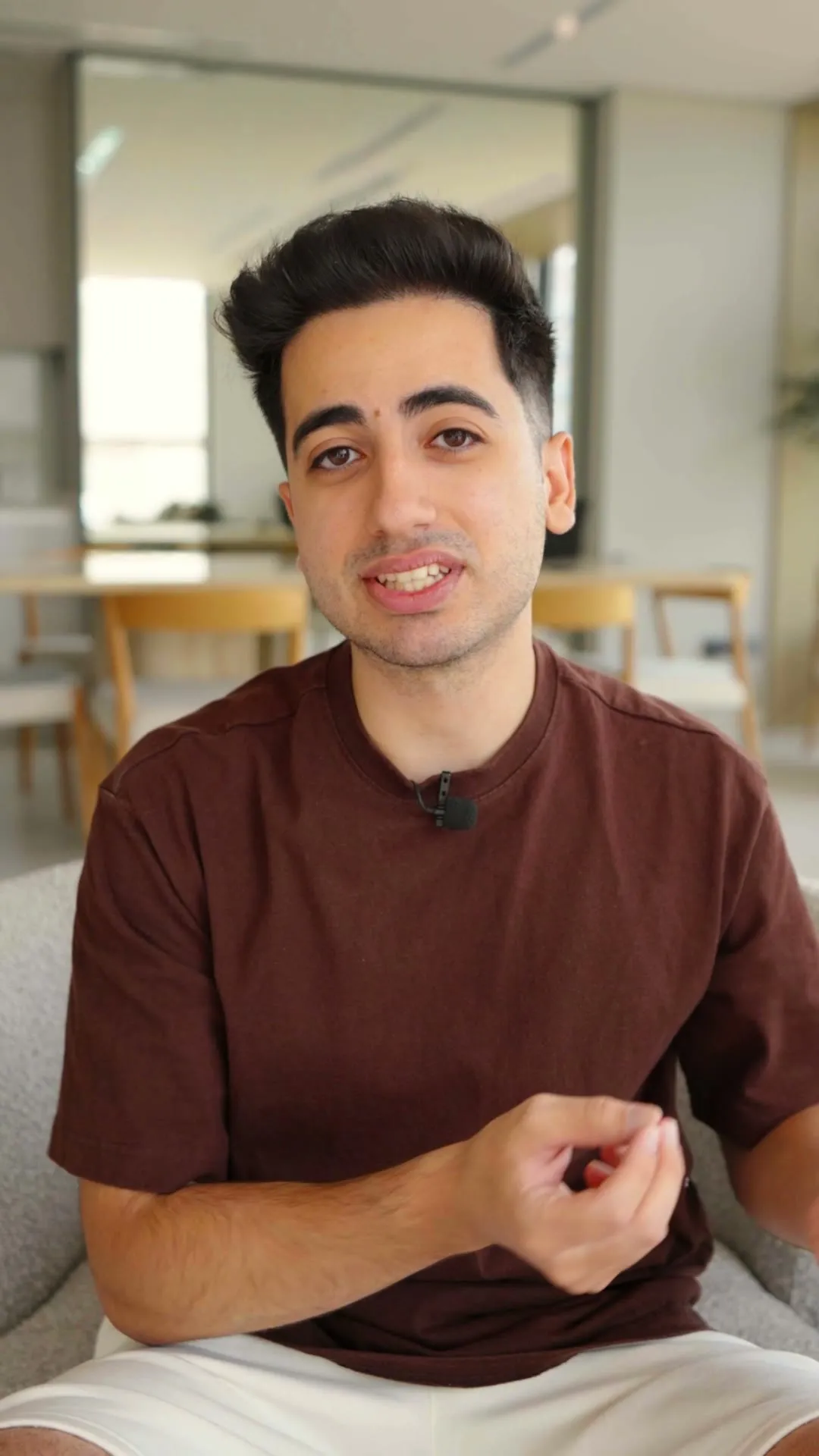 A creator talking to camera in a bright living room